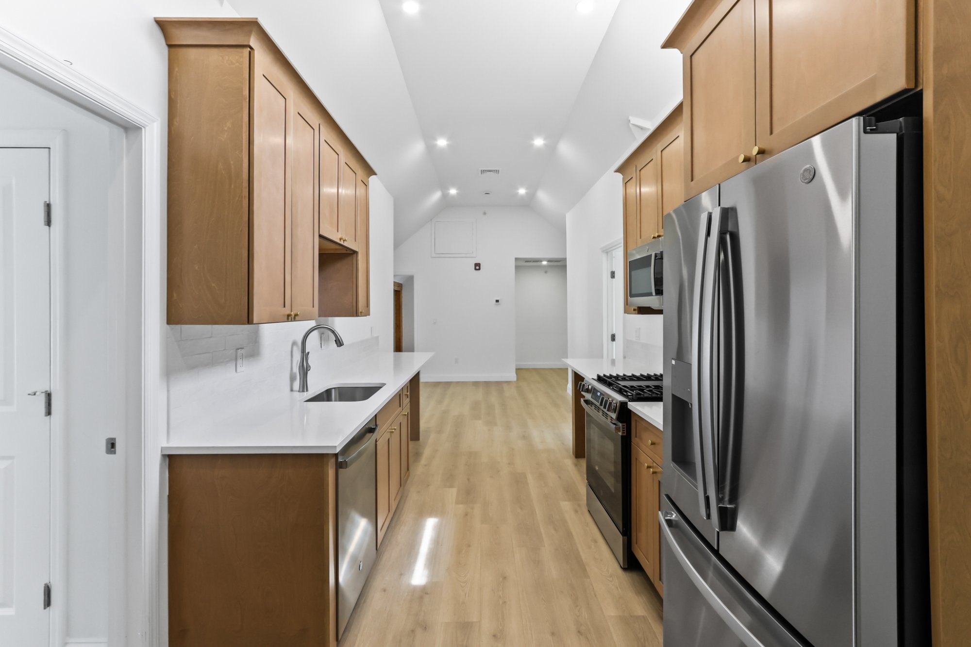 Living area exposed beam open to kitchen