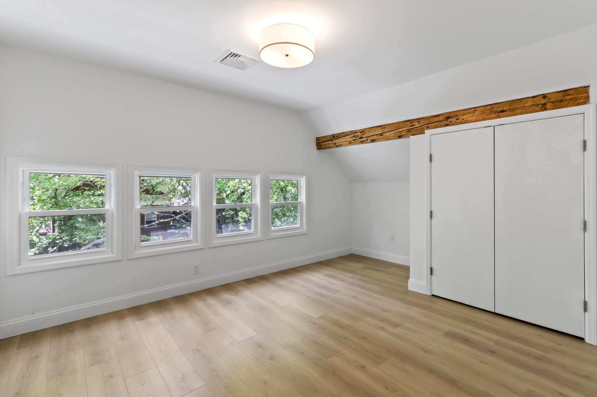 Open living area exposed beam and kitchen view