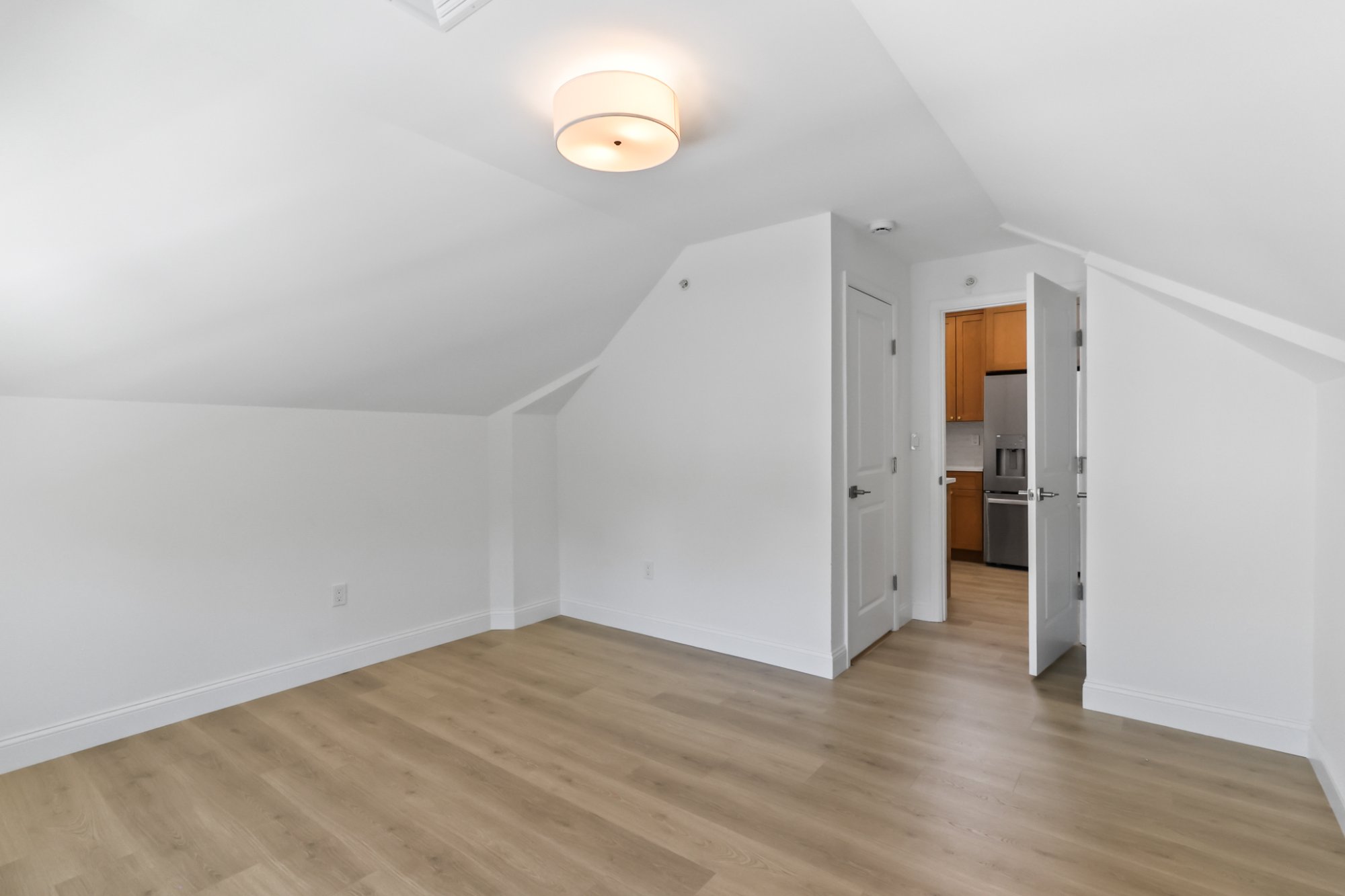 Bedroom with exposed beam and door
